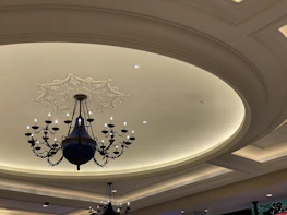 A beautifully decorated room featuring elegant gypsum ceiling designs with soft lighting.