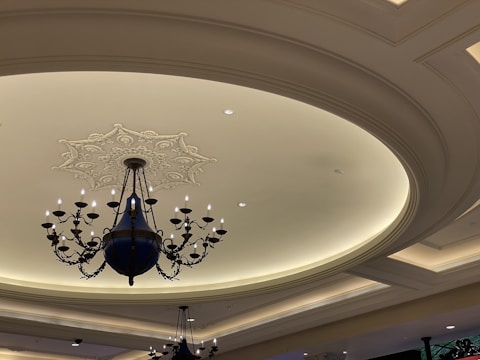 A ceiling with artistic false ceiling design and soft ambient lighting.