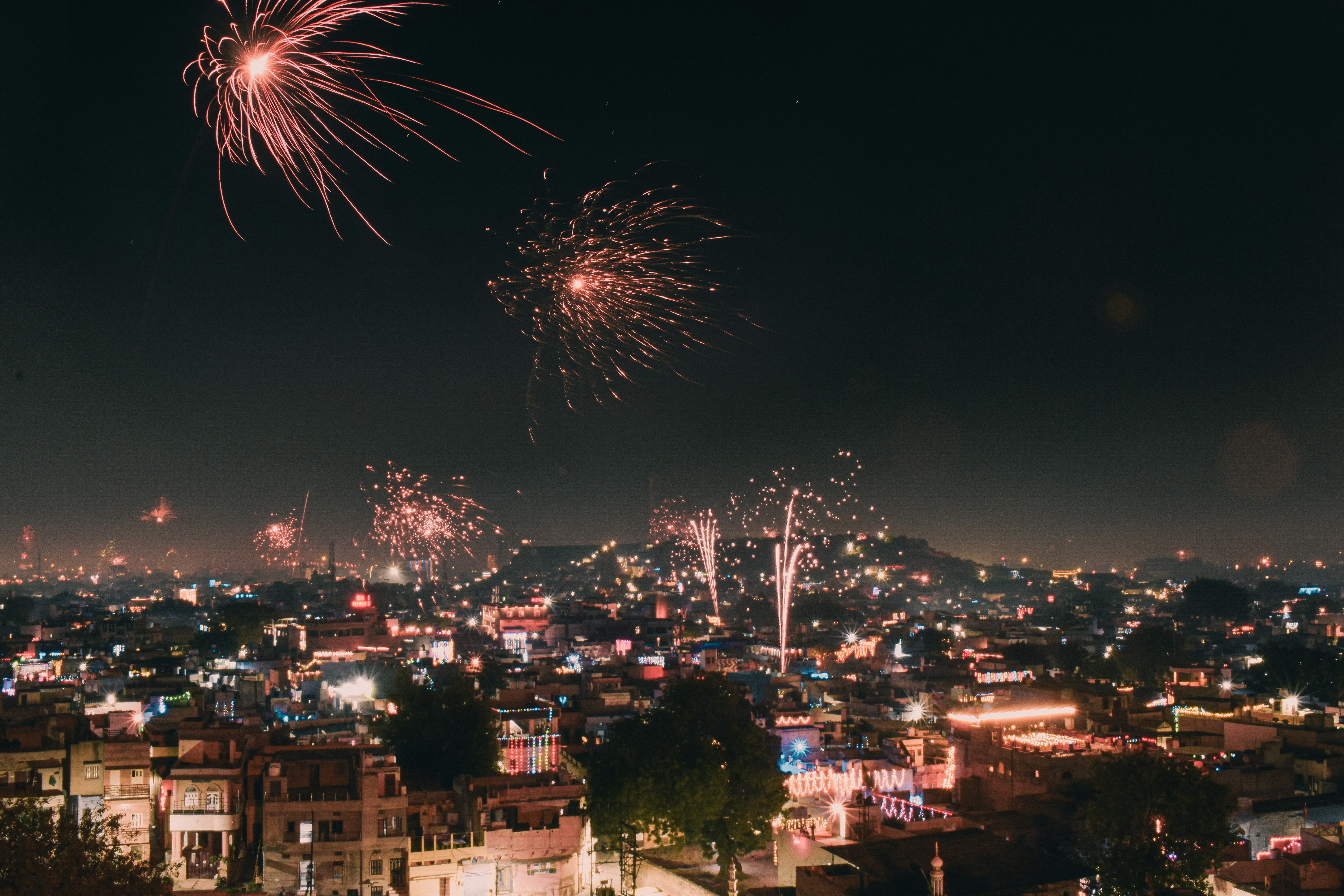 A fireworks display over a city at night