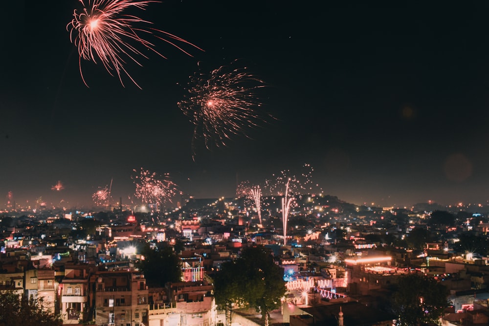 a fireworks display over a city at night