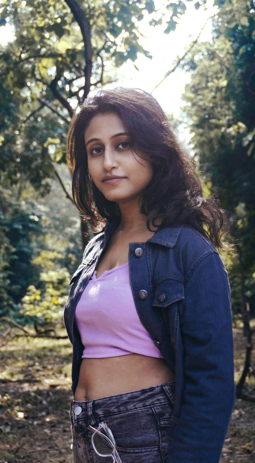 a woman in a pink shirt and jean jacket