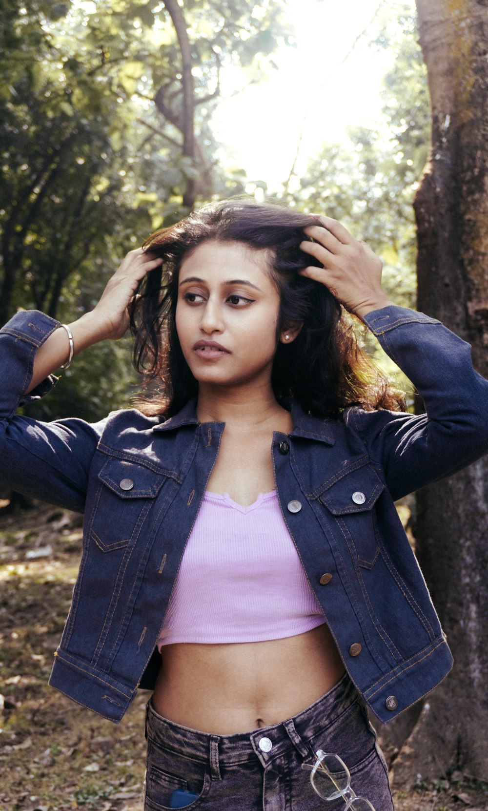 a woman in a pink top and jean jacket