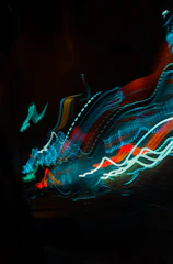 A swirling vortex of neon colors blending into surreal dreamscapes with pixelated retro shapes.