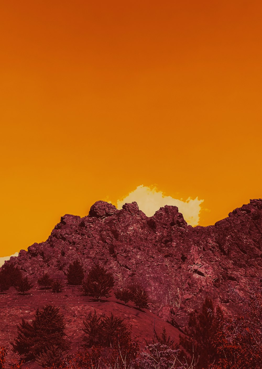 a red and orange sky over a mountain range