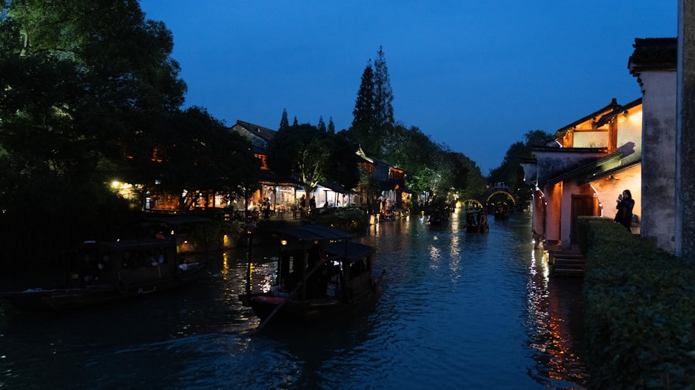 a river with a few boats on it at night