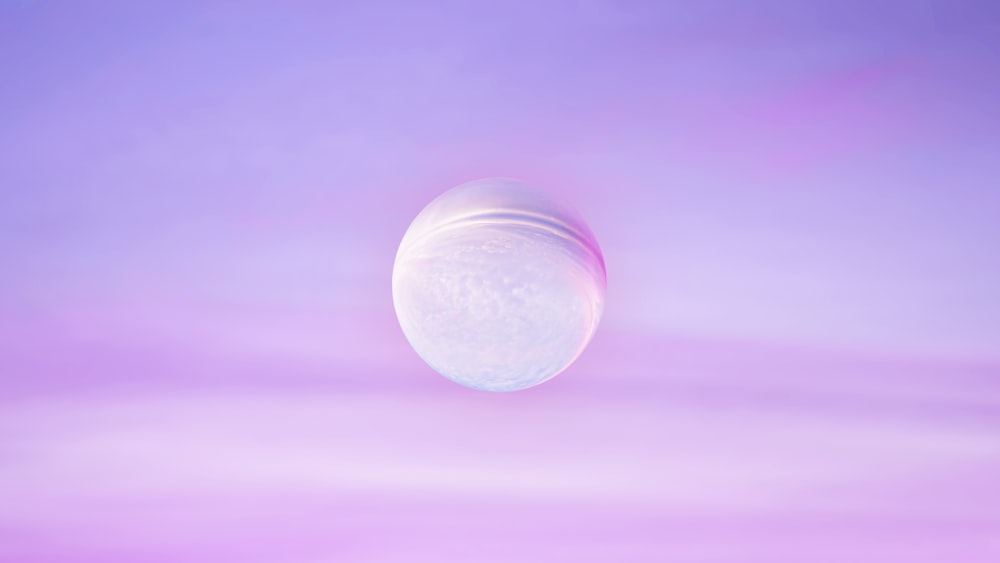 a large white object in the middle of a purple sky