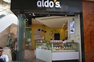 A cheerful ice cream shop interior with bright pastel walls, playful decorations, and happy customers enjoying their treats.