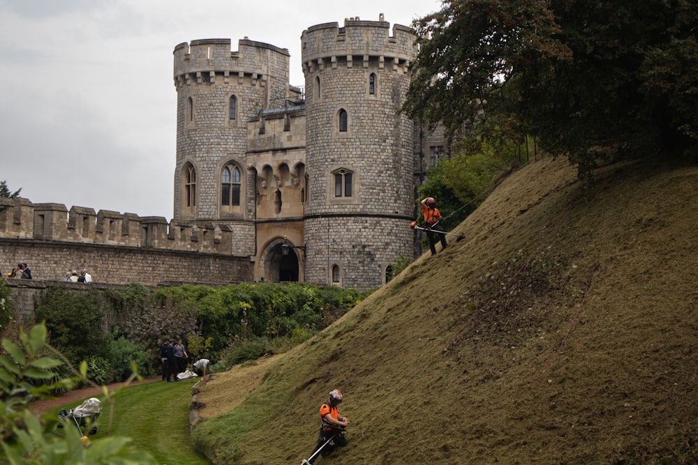 a couple of people riding bikes down a hill