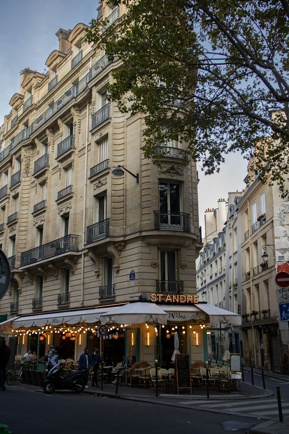 a street corner with a building and a cafe