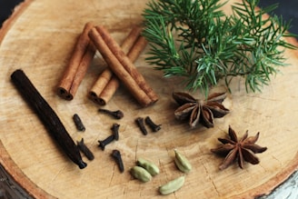 an assortment of spices sitting on top of a wooden cutting board