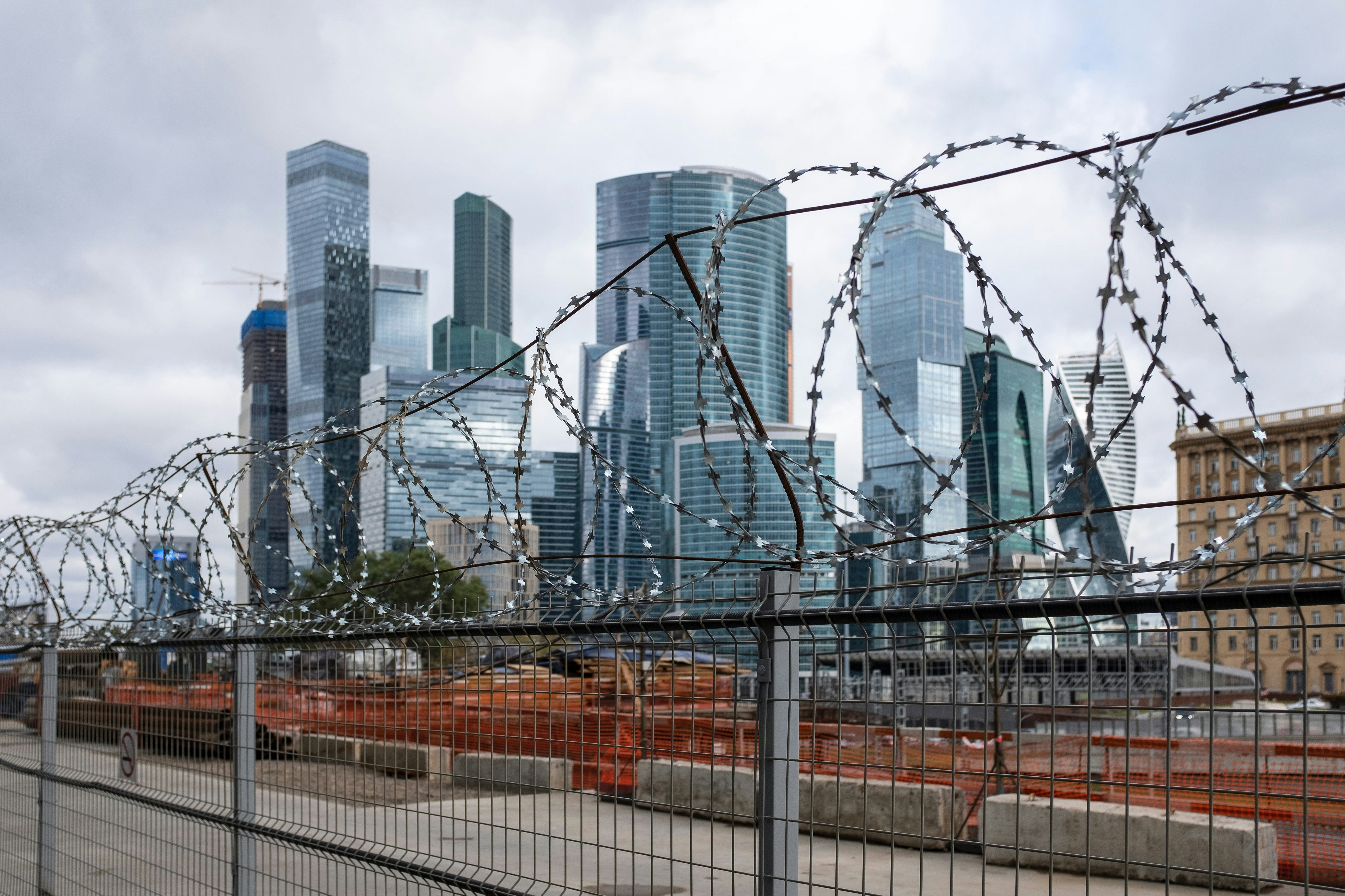 a view of a city from behind a fence