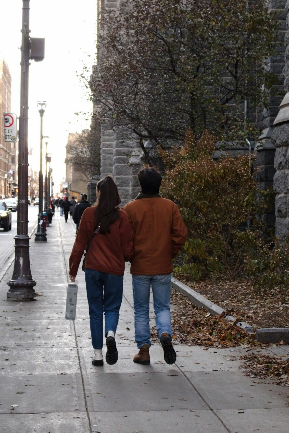 a man and a woman walking down a sidewalk