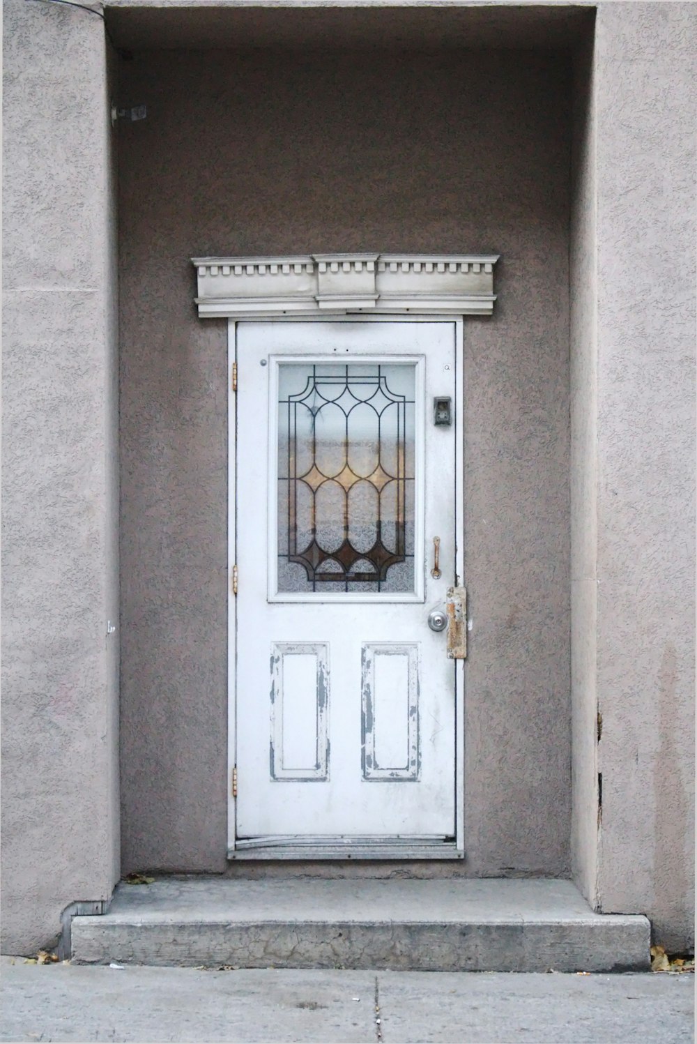 a white door with a window on the side of a building