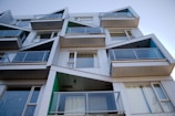 Contemporary residential building facade showcasing clean lines and glass balconies.