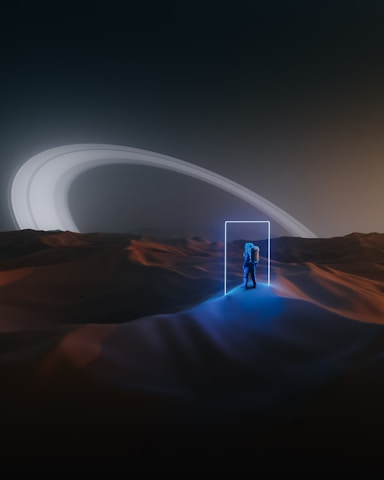 An astronaut stands in an alien desert landscape, illuminated by a glowing, rectangular portal. The terrain is softly lit with hues of blue and orange, and in the distance, the rings of a large planet arc across the sky under an eerie, futuristic glow.