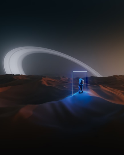 An astronaut stands in an alien desert landscape, illuminated by a glowing, rectangular portal. The terrain is softly lit with hues of blue and orange, and in the distance, the rings of a large planet arc across the sky under an eerie, futuristic glow.