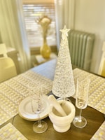 A set of sparkling crystal mementos with engraved names and dates, softly illuminated.