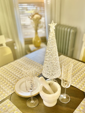 A set of sparkling crystal mementos with engraved names and dates, softly illuminated.