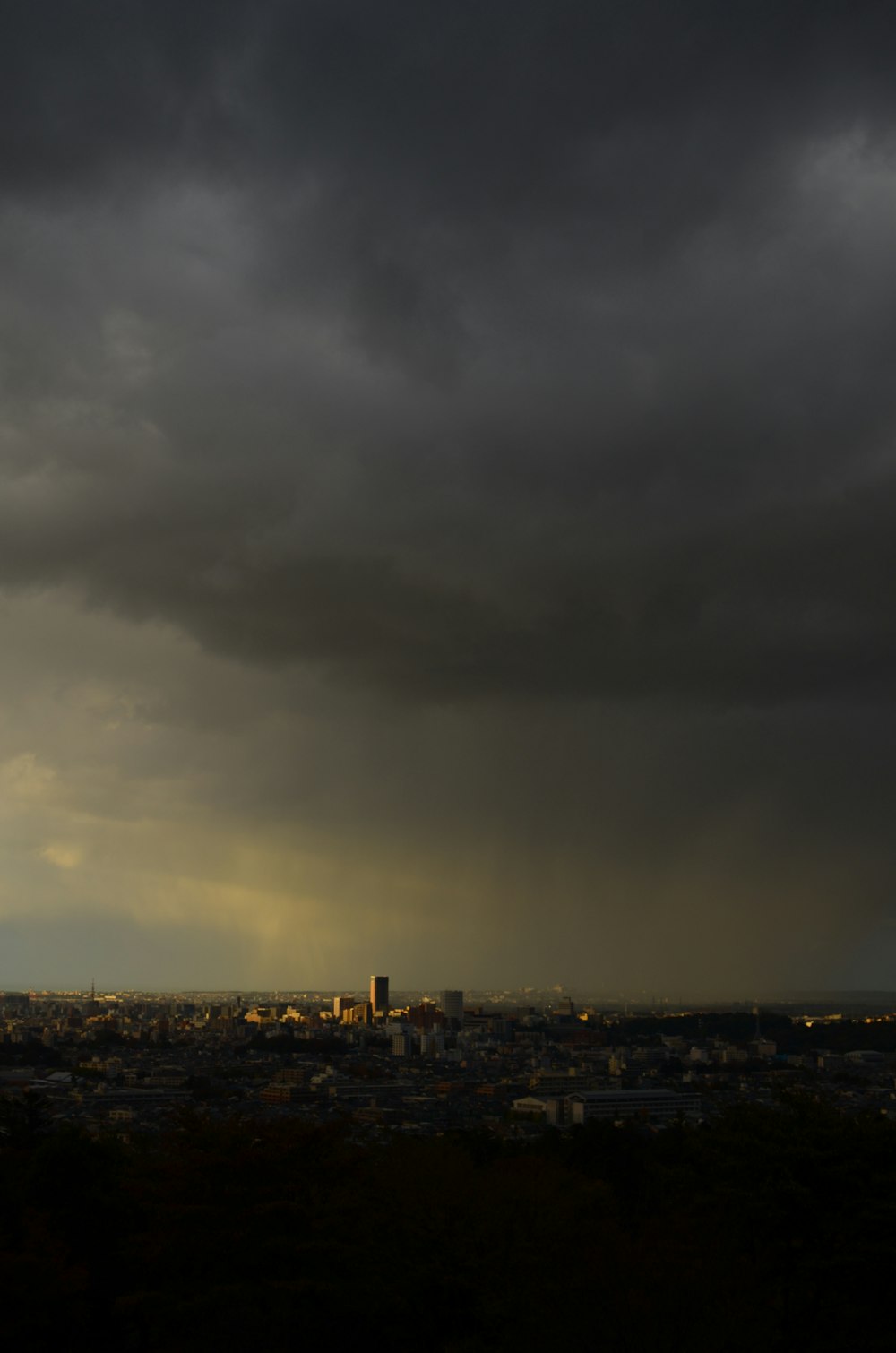 a cloudy sky over a city with a clock tower