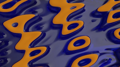 A digital abstract pattern featuring wavy orange shapes outlined in dark blue on a shiny, reflective blue surface. The design forms a fluid, flowing arrangement that resembles organic forms or symbols.