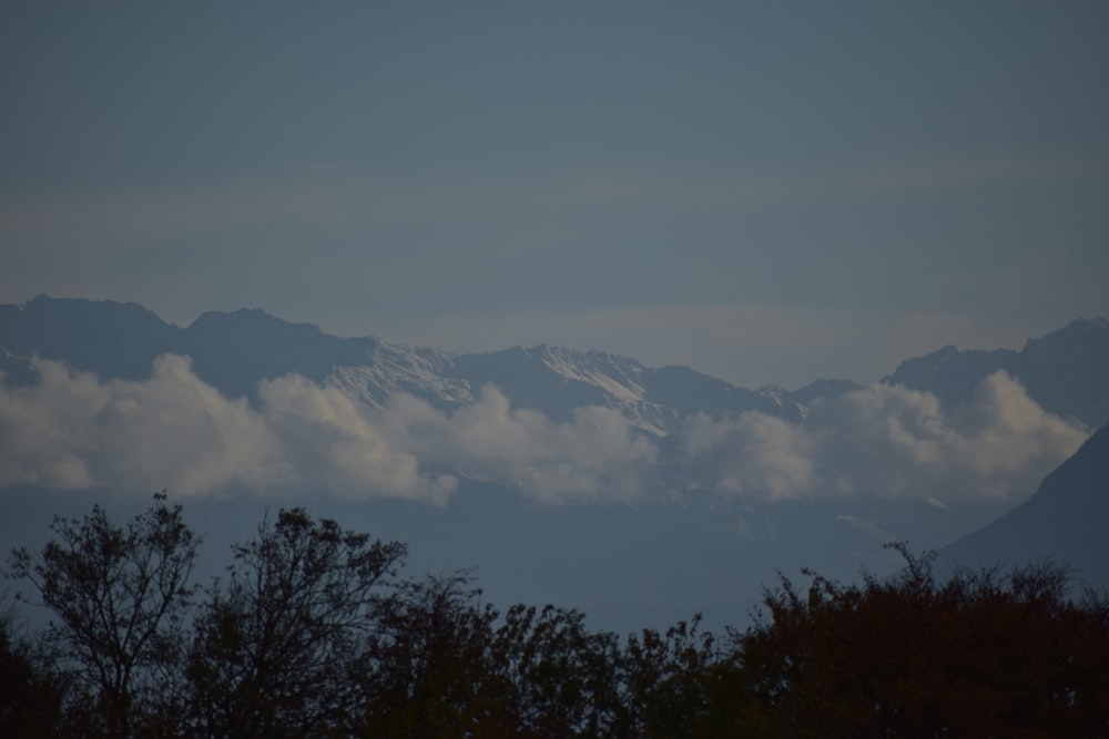 a view of a mountain range with clouds in the foreground