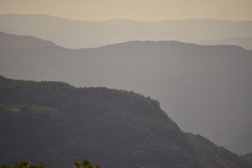 a view of a mountain range with trees in the foreground