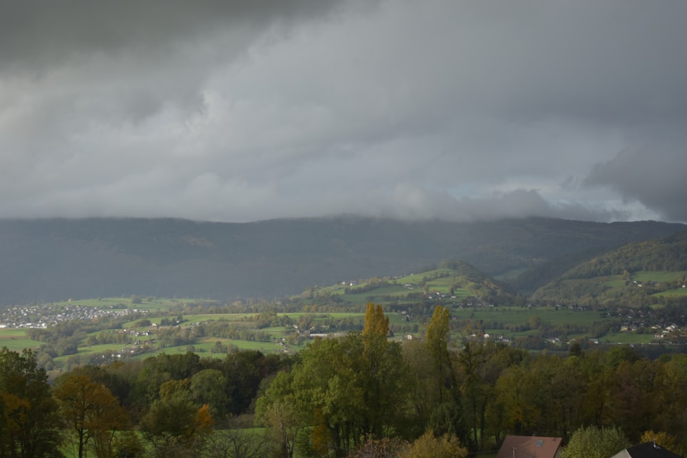 a view of a valley with mountains in the background