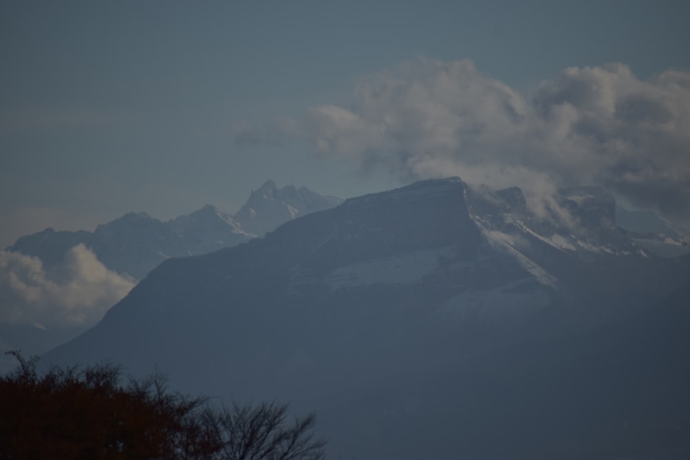 a view of a mountain range with clouds in the sky