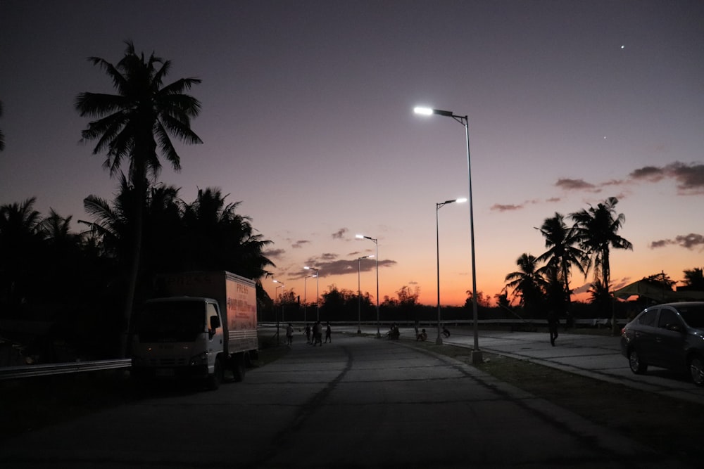 a car parked on the side of a road next to a street light