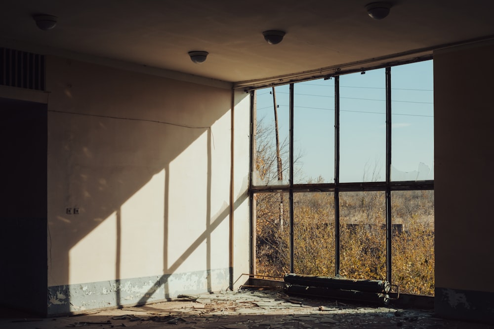 an empty room with a window and a view of a field