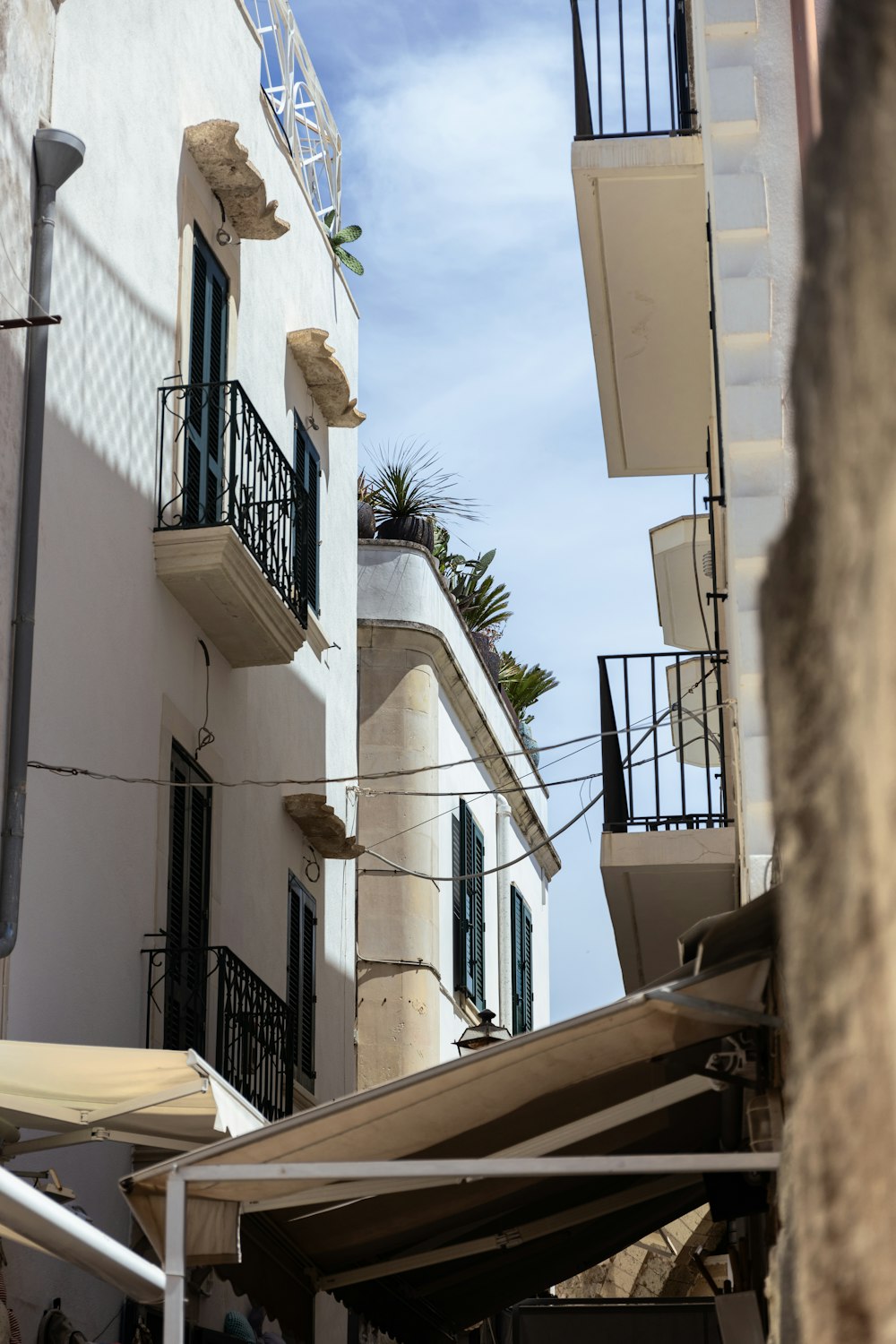 a white building with a balcony and balconies