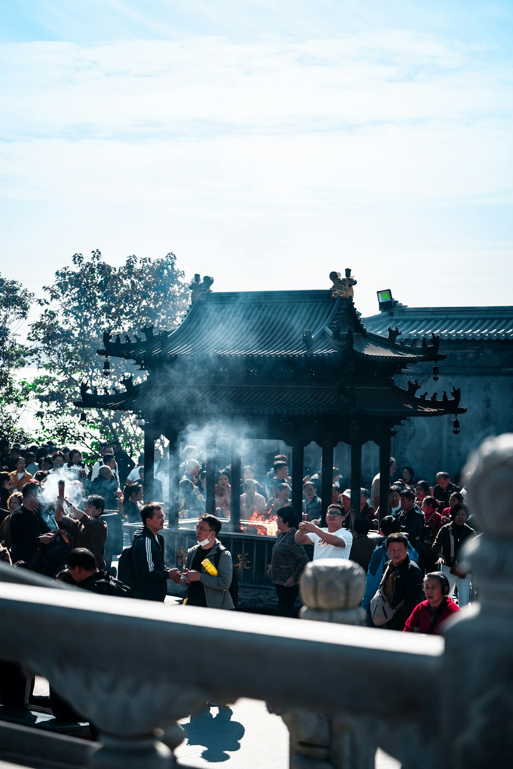 a group of people standing around a pavilion