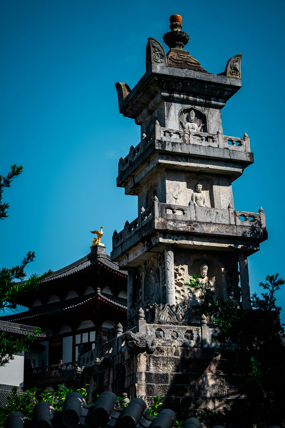 a tall tower with a statue on top of it