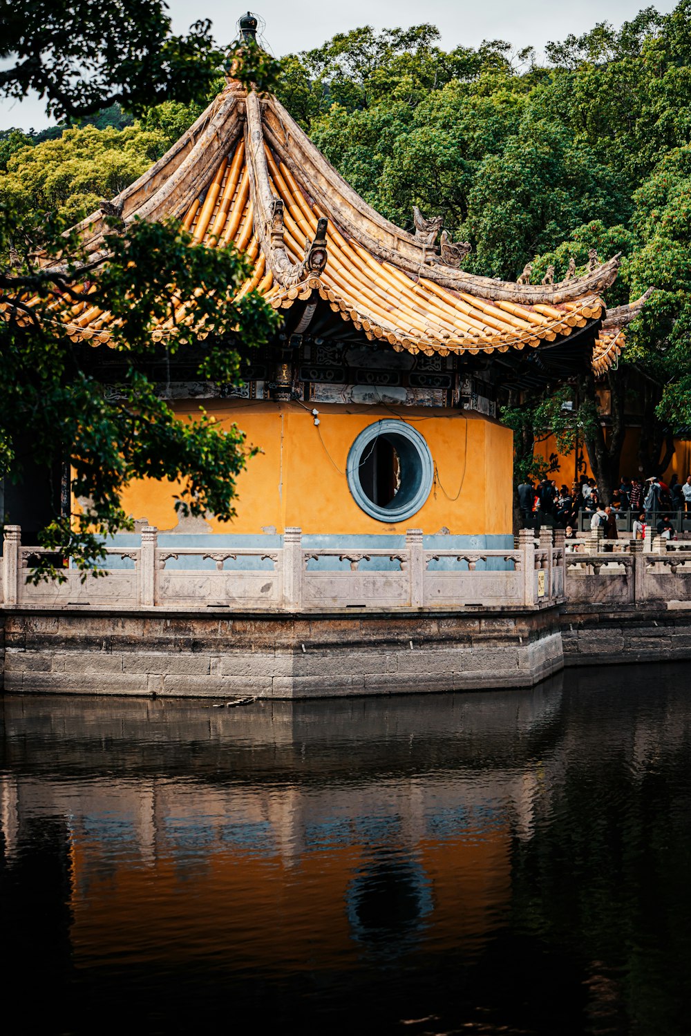 a yellow building sitting next to a body of water