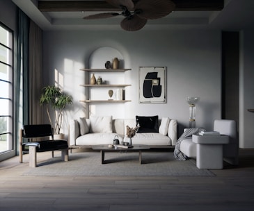 a living room filled with furniture and a ceiling fan