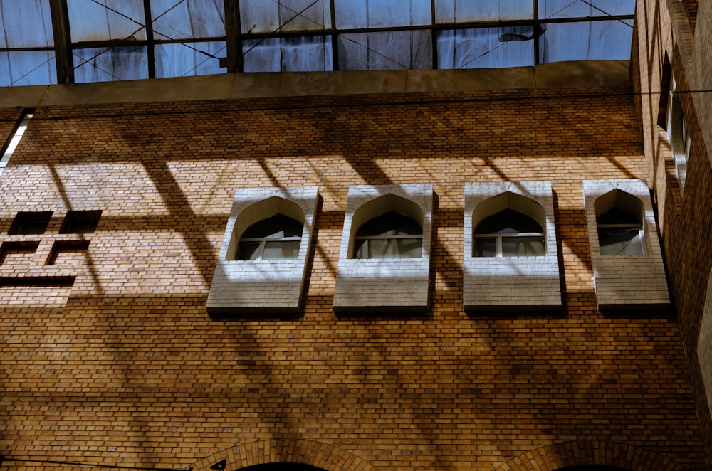 a brick building with several windows on the side of it