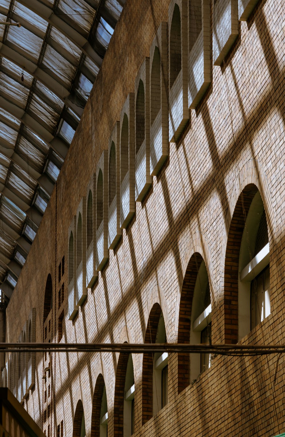 a brick building with arched windows and a skylight