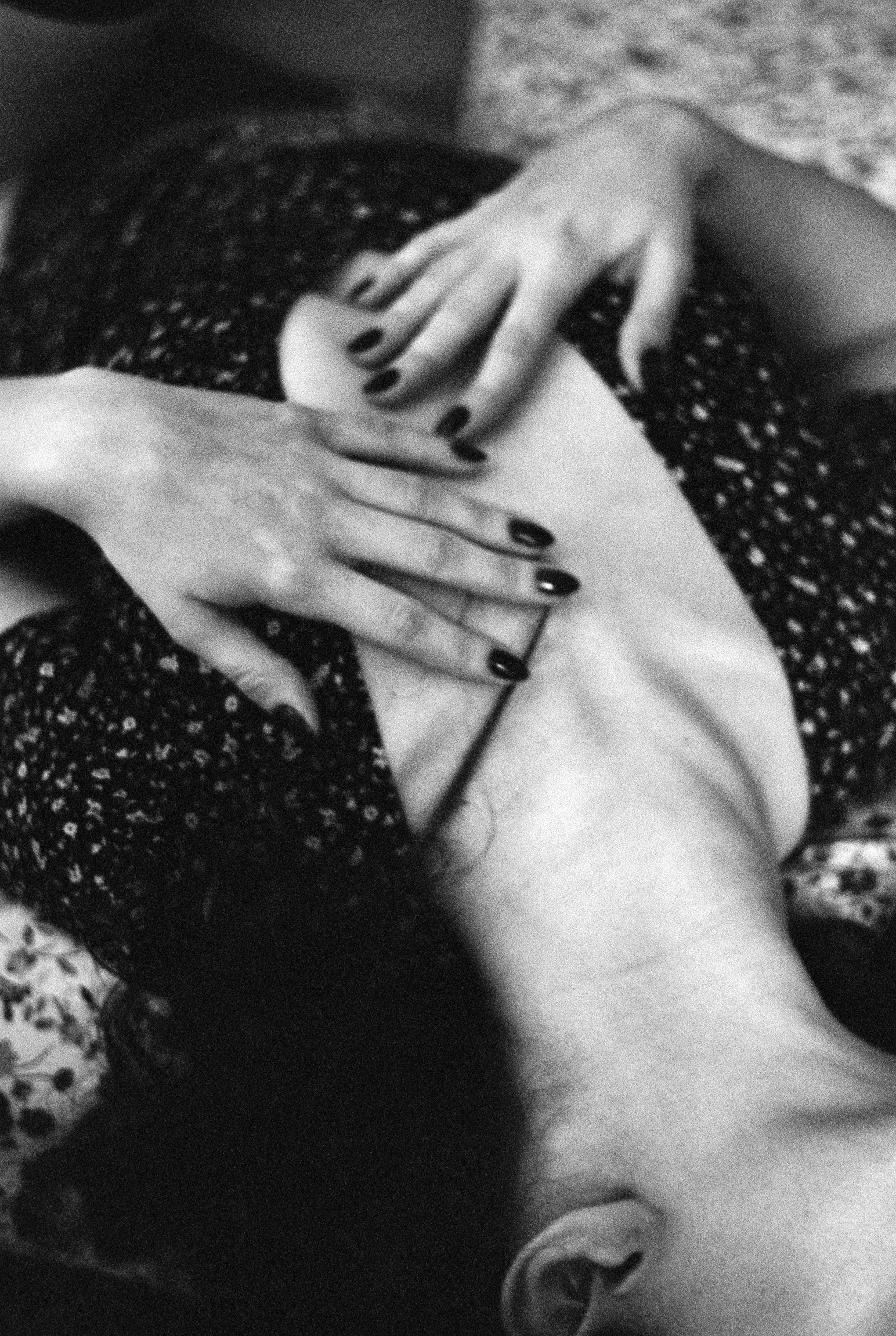 a woman laying on top of a bed with her hands on her chest