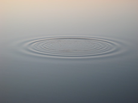 A softly glowing timeline diagram illustrating ripple effects from a small change in history.