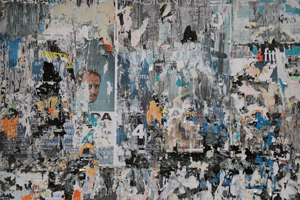 a painting of a man's face surrounded by torn up papers
