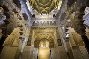 Intricate Islamic architectural details with ornate arches, elaborate decorative patterns, and detailed mosaics on the walls and ceiling, creating a sense of grandeur and artistry.
