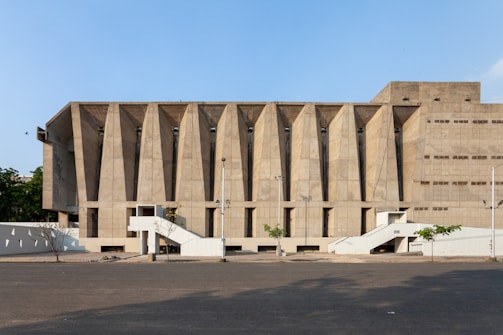Wide shot of a public building with bold concrete pillars and open spaces.