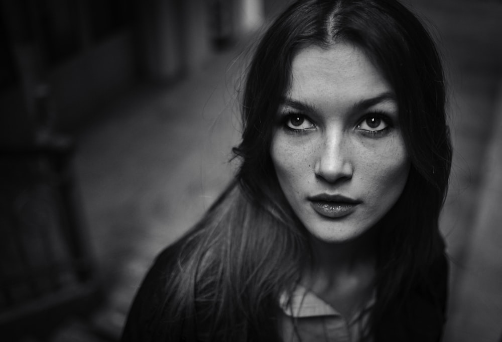 a black and white photo of a woman with long hair