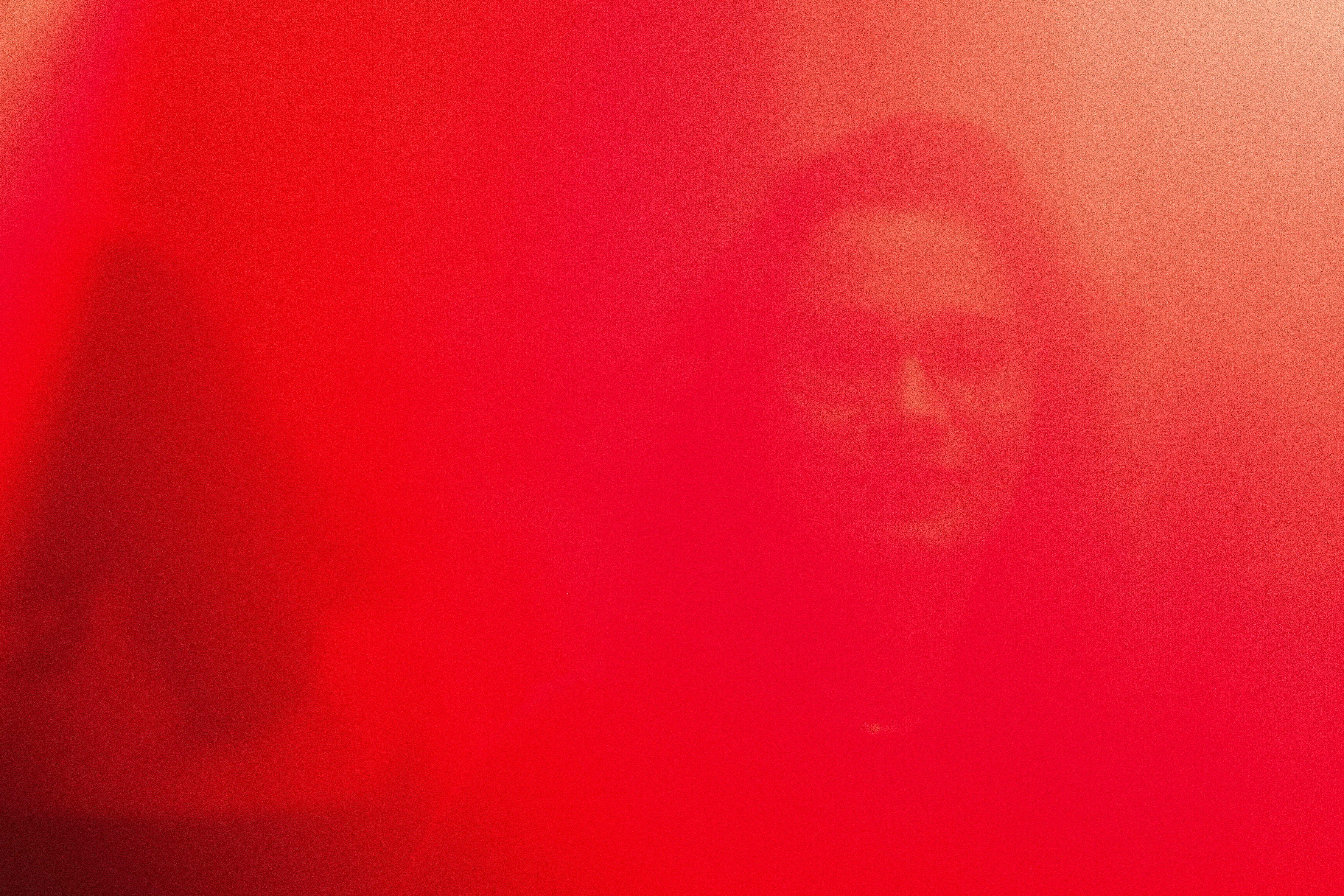 a woman standing in front of a red light