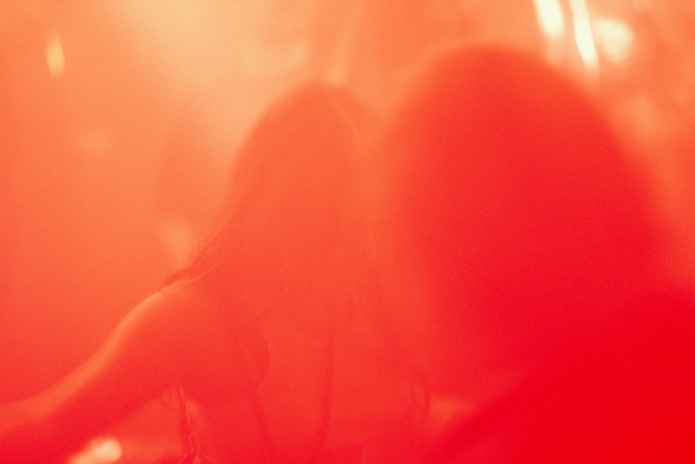 a woman standing in front of a red light