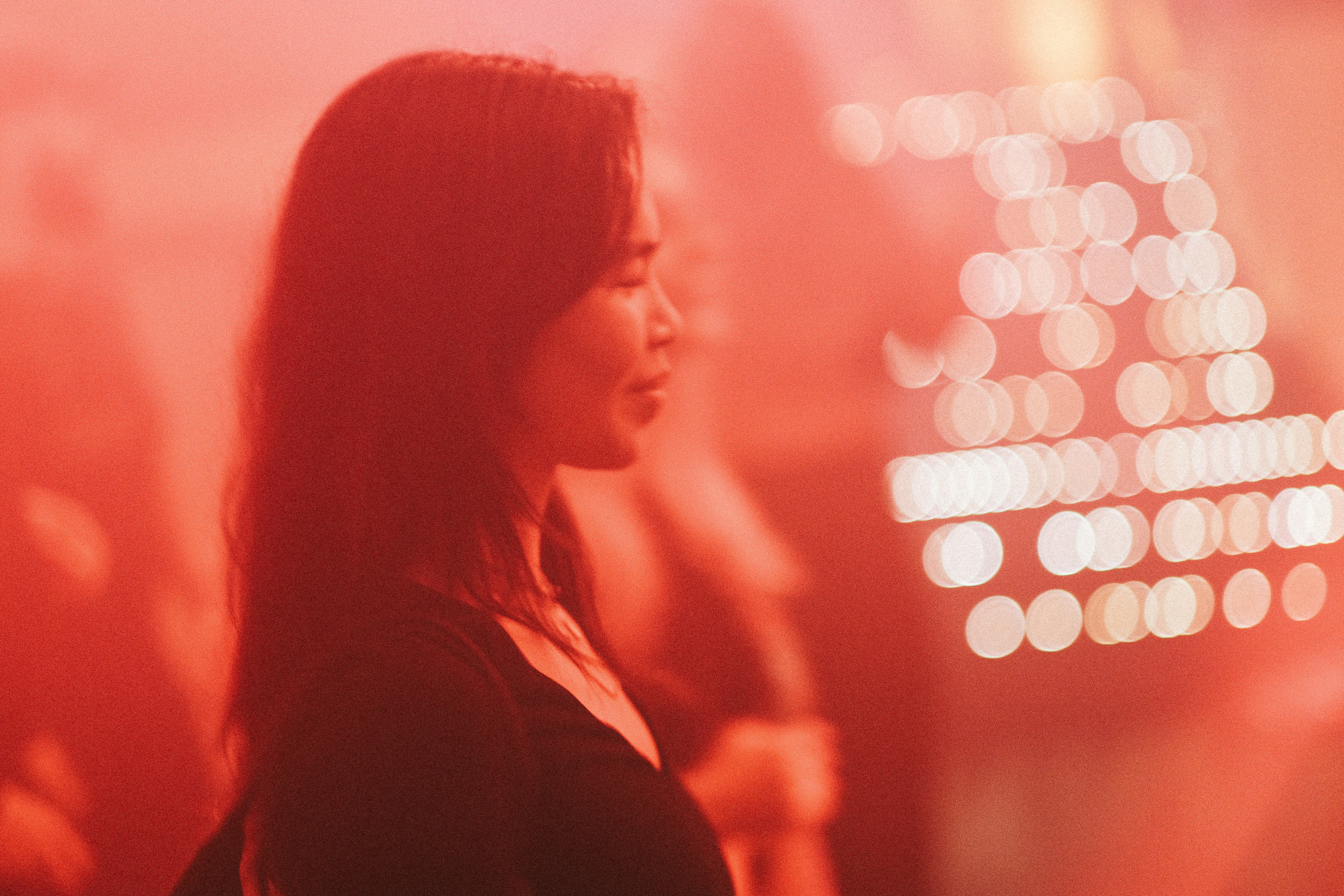 a woman standing in front of a red light