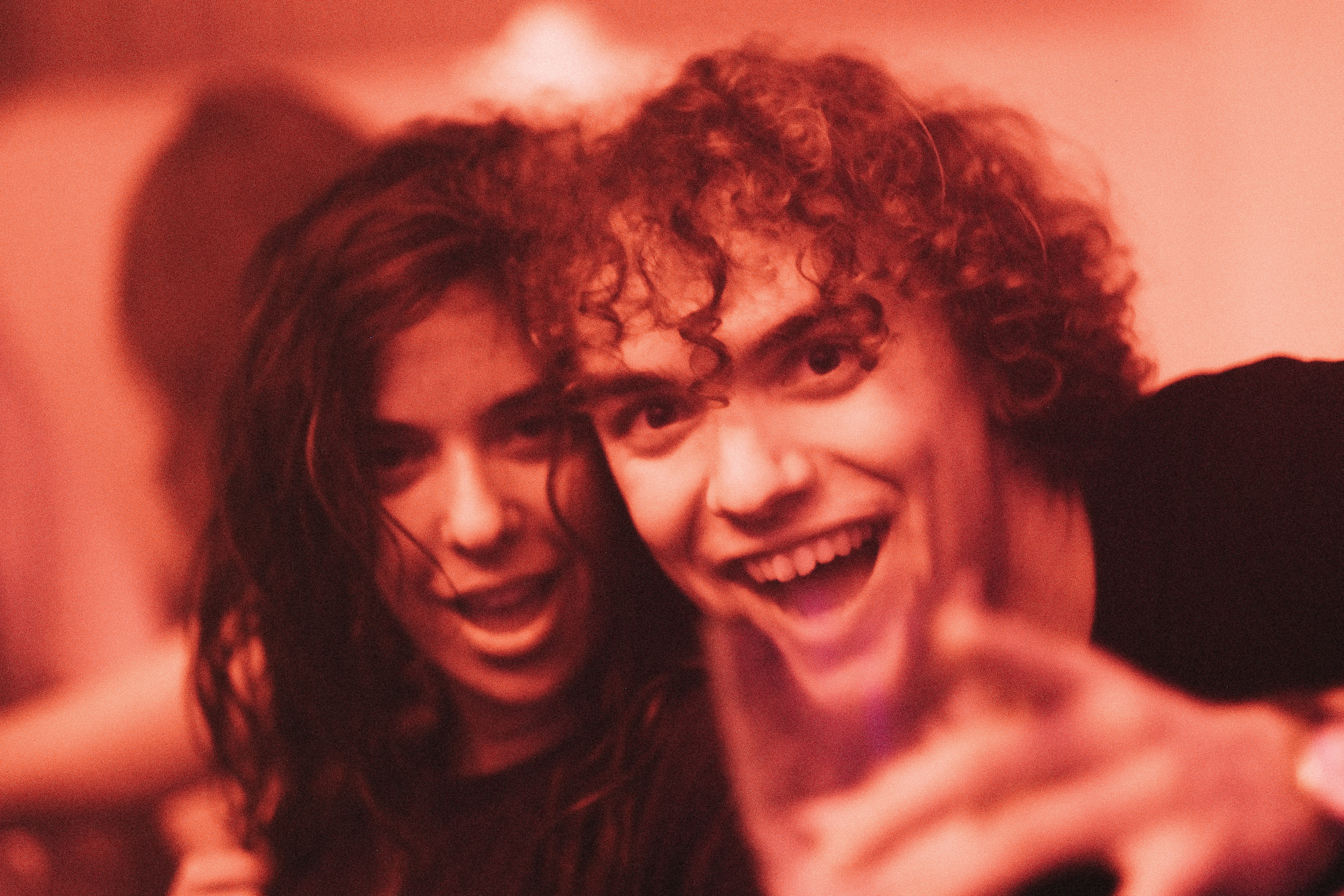 a couple of young men standing next to each other