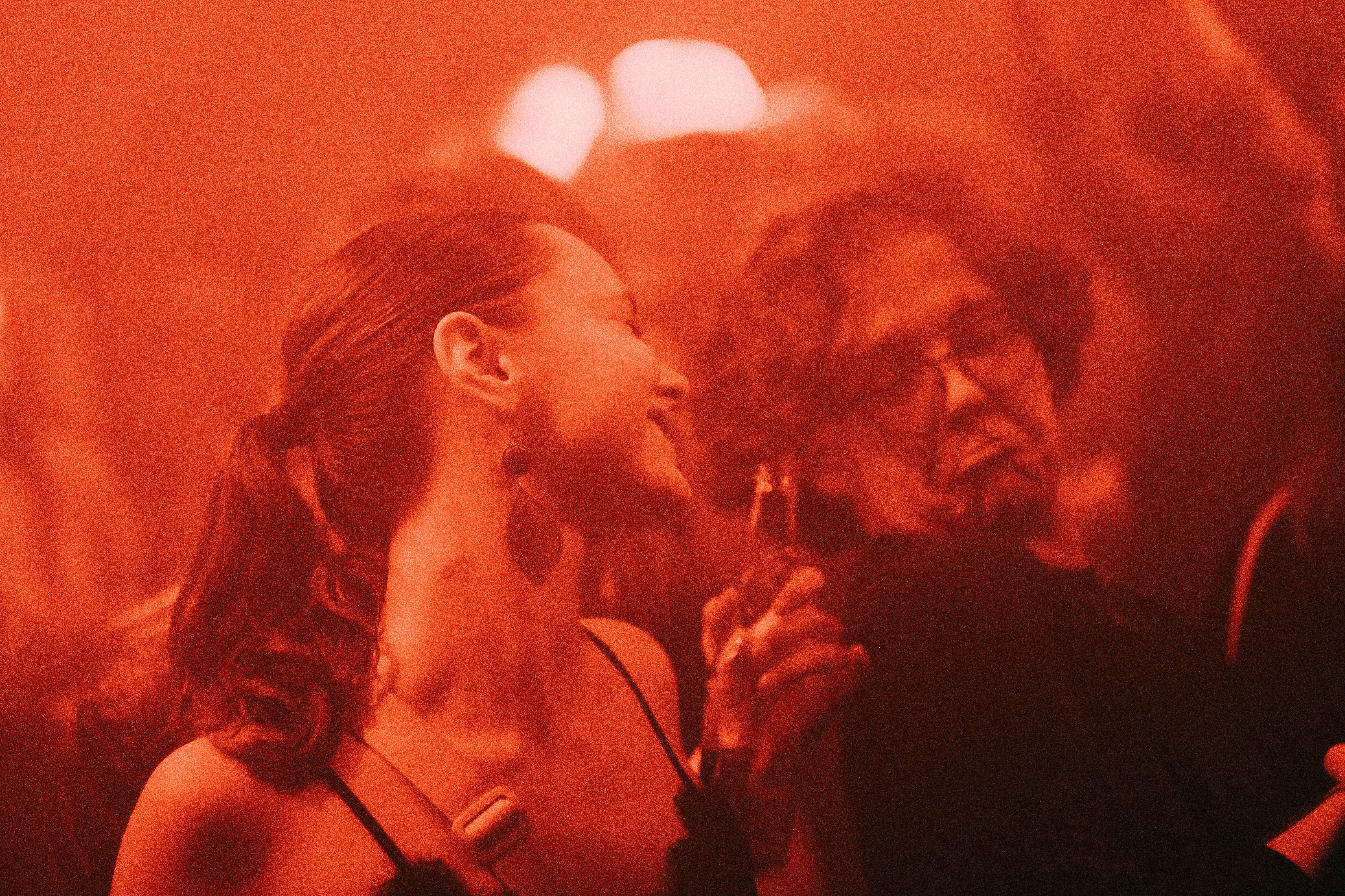 a woman standing next to a man in a crowd