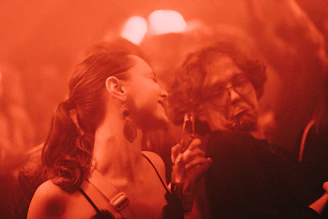 a woman standing next to a man in a crowd