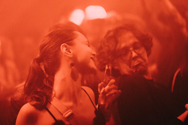 a woman standing next to a man in a crowd